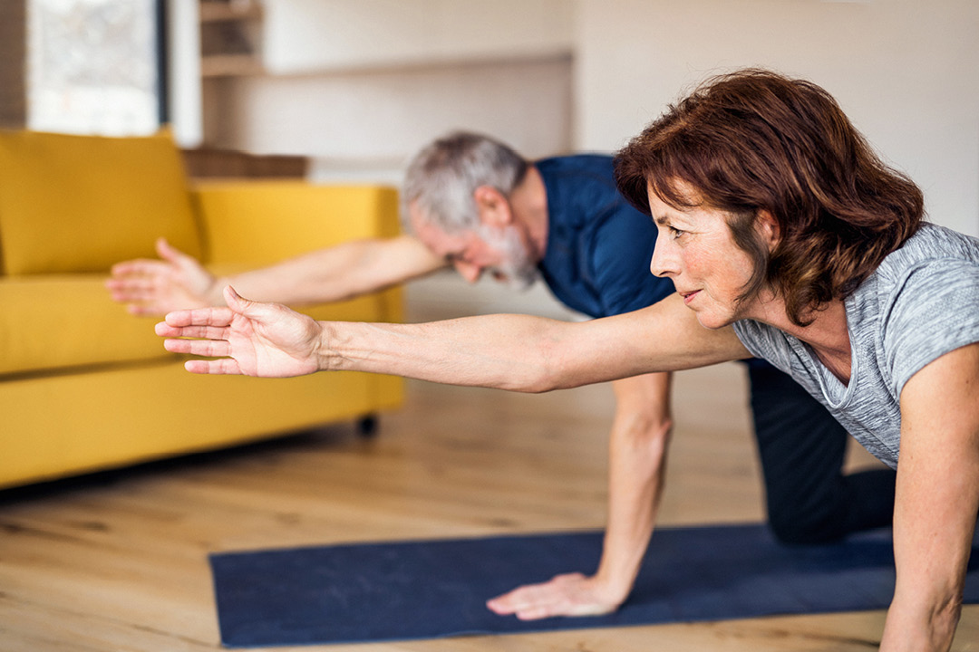 man and woman stretching on yoga mats